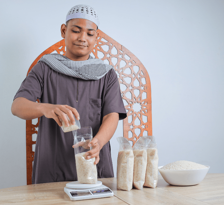 Hombre musulmán pesando y calculando arroz para distribuir como Zakat