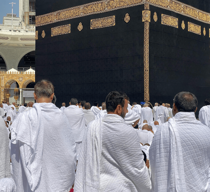Personas caminando cerca de la Kaaba en La Meca representando la historia de la Qibla